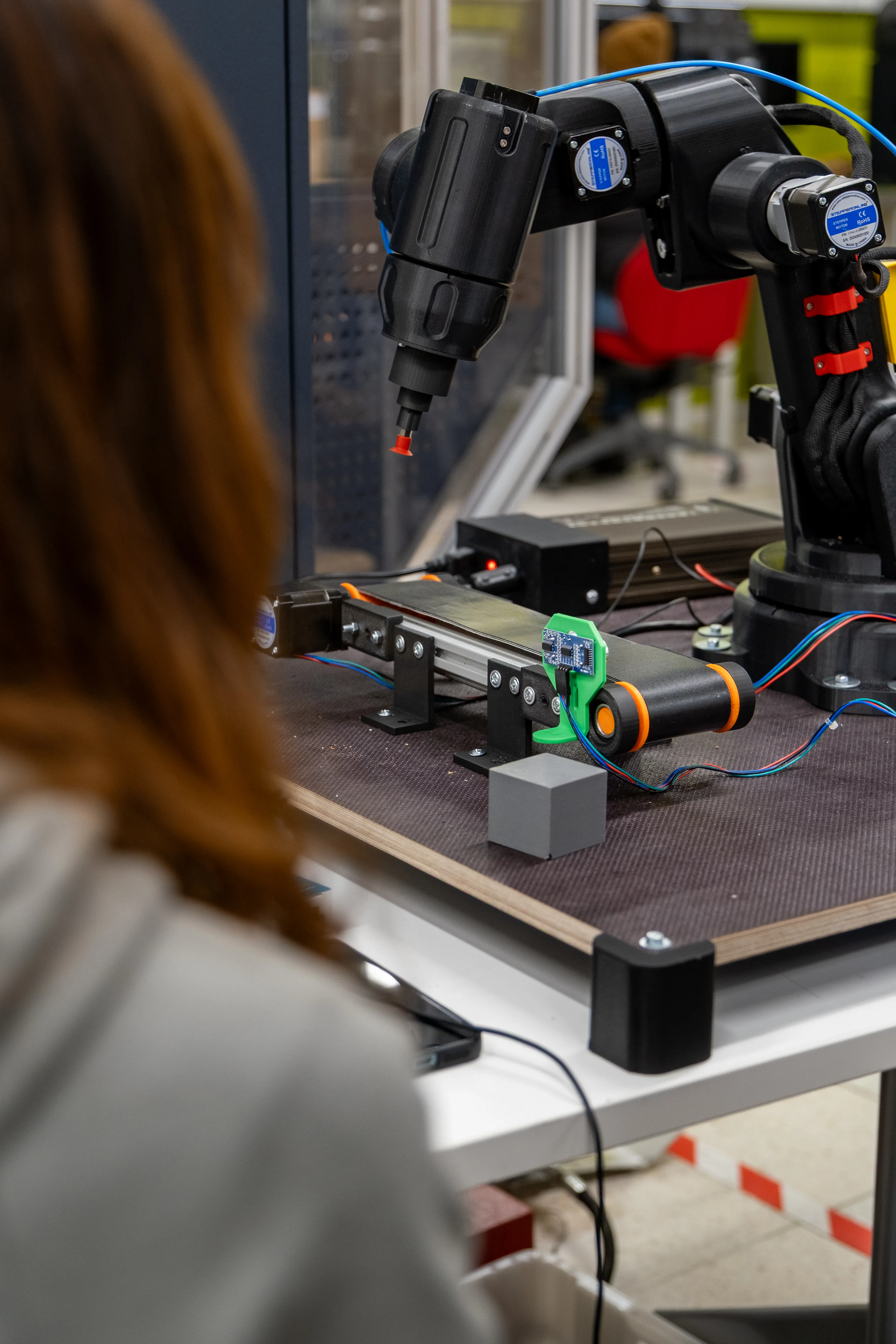 Student looking at Proto-GK-RA robot.